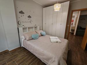 a bedroom with a bed with two towels on it at Dreaming Ribera del Genil - free parking in Granada +19 photos