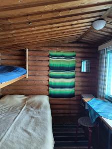 a room with two bunk beds in a cabin at Lomakylä Lapponia in Inari +35 photos