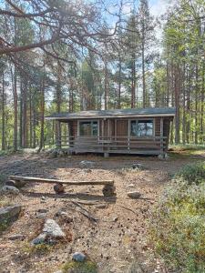 a small cabin in the middle of a forest at Lomakylä Lapponia in Inari