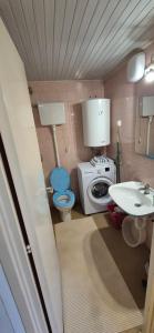 a small bathroom with a toilet and a sink at Stan - centar Igalo in Igalo +6 photos