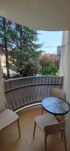 a balcony with a table and two chairs and a window at Stan - centar Igalo in Igalo