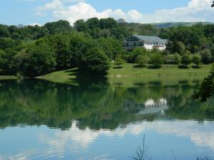 a view of a lake with a house in the background at Hermida Rural in Eirejalba +39 photos