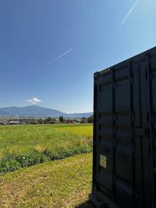 a black trailer sitting in a field of grass at Tinyhome Murtal -SlowCamping in Fohnsdorf