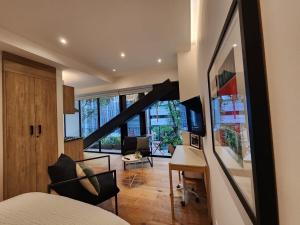 a bedroom with a bed and a desk in a room at Steps to Historic C and Reforma in Mexico City