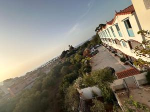 an aerial view of a town with buildings and trees at Résidence île des Pisans Nezla in Bejaïa