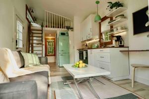 a kitchen and living room with a couch and a table at Red Barn Cabin Near Okemo in Brownsville +16 photos