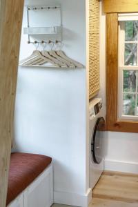 a tiny house with a white wall and a shelf at Red Barn Cabin Near Okemo in Brownsville