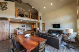 a living room with a table and a couch at Townhome next to Clubhouse in Exclusive Eagle Bend - The Glacier in Bigfork