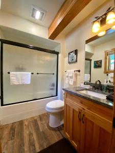 a bathroom with a shower with a toilet and a sink at Townhome next to Clubhouse in Exclusive Eagle Bend - The Glacier in Bigfork +25 photos