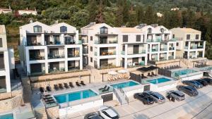an aerial view of a hotel with cars parked in a parking lot at Ionian Pearl Studio in Nikiana