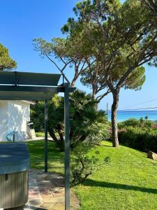 a picnic shelter with a view of the ocean at Villa Beachfront Marina in Santa Margherita di Pula