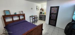 a bedroom with a bed and a kitchen with a table at Depto SOSKE in Loreto
