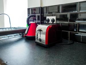 a toaster and a toaster on a kitchen counter at Bucknall Lodge Hanley Family Room 4 in Stoke on Trent