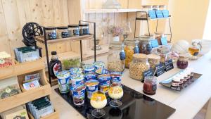 a display of jars of food and other items on a table at Rezydencja Dwór Górny in Nowa Ruda