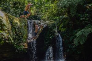 two men standing on top of a waterfall at Ecotone Manu Learning Center, All-Inclusive in Pillcopata +3 photos