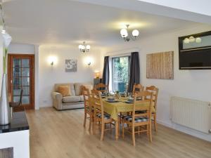 a dining room and living room with a table and chairs at Belmont in Longton