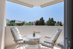 a patio with a table and chairs on a balcony at Apartment Paula in Novalja