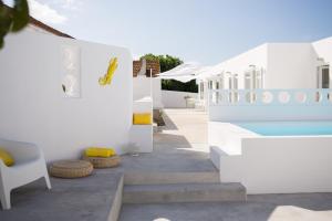 a white house with a swimming pool and stairs at CASASUPERTUBOS - Apart 1-8 in Atouguia da Baleia