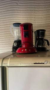 a red blender sitting on top of a counter at Casa na orla in Porto Seguro