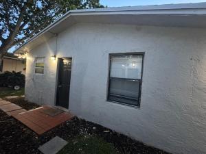 a white house with a window and a door at Pacifica Fort Lauderdale Airport in Dania Beach +9 photos
