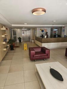 a lobby with a couch and a counter in a hospital at Apartamento Praia do Centro Pipa in Pipa