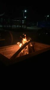 a fire pit at night with flames in it at Yanis Resort in Calatagan +2 photos
