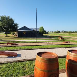 a group of barrels sitting on the grass at Fredericksburg Escape Wineries & Hot Tub in Fredericksburg