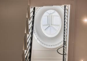 a round window in a wall in a room at Blythswood Apartments - Experience Luxury Living in Glasgow