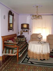 a living room with a table and a chair at Señorío de Monterruiz in Casas de Santa Cruz