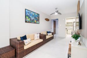a living room with a couch and a painting on the wall at Apartamento Garden Caiobá com Piscina Praia Brava in Matinhos