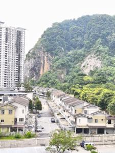 a city with buildings and a mountain in the background at Angsana Raintree Batu Caves with balcony 3Bedroom 2Bathroom in Batu Caves