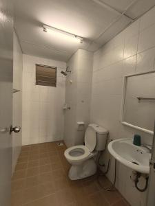 a bathroom with a toilet and a sink at Angsana Raintree Batu Caves with balcony 3Bedroom 2Bathroom in Batu Caves