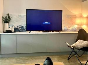 a television sitting on a cabinet in a living room at Konayuki Apartment 1 in Falls Creek