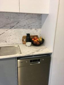 a kitchen with a bowl of fruit on a counter at Konayuki Apartment 1 in Falls Creek +3 photos