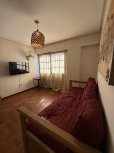 a bedroom with a large bed and a window at Hermoso departamento a una cuadra casa historica in San Miguel de Tucumán