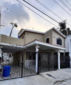 a house with a gate in front of it at Casa Luna in Ciudad Madero