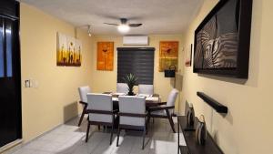 a dining room with a table and chairs at Casa Luna in Ciudad Madero