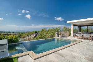 a swimming pool in the backyard of a house at Prasana Villas Uluwatu in Uluwatu