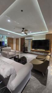 a living room with couches and a flat screen tv at One Euphoria Luxe Hotel in Angeles