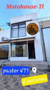 a building with a sign on the side of it at MotoHouse-Tl in Trenque Lauquen +2 photos