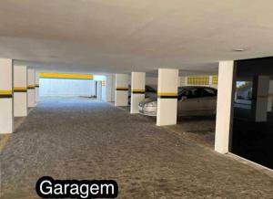 a garage with two cars parked in it at Flat vista mar in Cabedelo