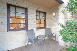 two chairs sitting on the side of a building at Magnolia on Colville - Historic Riverside Elegance in Hobart