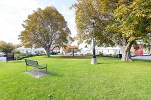 a park with a bench and a street light at Magnolia on Colville - Historic Riverside Elegance in Hobart
