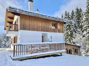 a cabin in the snow with a dog on the roof at Chalet indépendant avec spa, sauna et cheminée à Notre-Dame-de-Bellecombe - 10 pers - FR-1-595-102 in Notre-Dame-de-Bellecombe