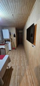 a room with a wooden floor and a flat screen tv at Apartamento tv wifi lavadora secadora in Los Ángeles