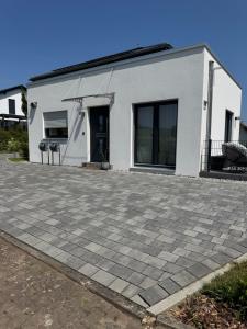 a white building with a driveway in front of it at FeWo S26 in Krumbach