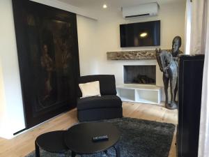 a living room with a chair and a horse statue at Bellechasse Apartments in Paris