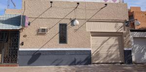 a building with two garage doors in front of it at Hotel Cielo Cuyano in San Juan