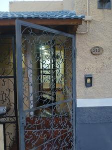 a door with a metal gate in front of a building at Hotel Cielo Cuyano in San Juan