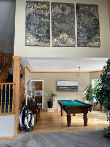 a living room with a pool table at The HI-Mark House - Hot tub,AC,Pool table, Pool May2026 in Sicamous